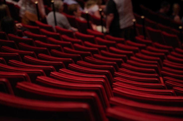 Rows of red chairs in the theatre