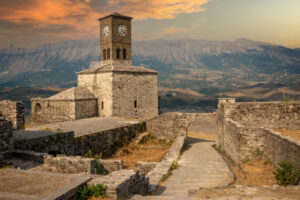 Gjirokaster Sunset over clock tower and fortress at Gjirokaster castle, Albania