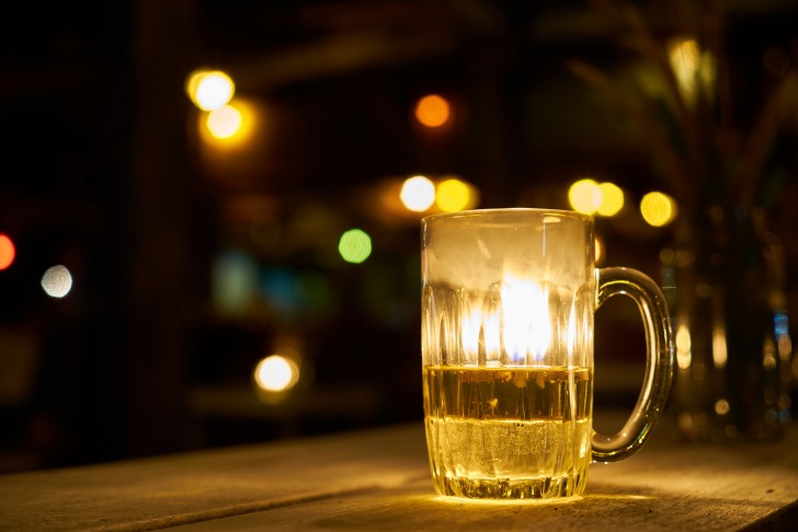 A glass of beer in the evening lights
