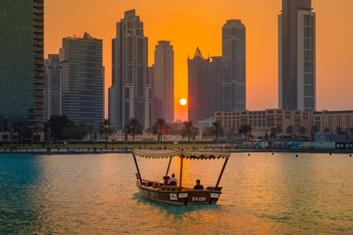 Sun sets behind skyscrapers