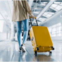 Walking in an airport with yellow luggage