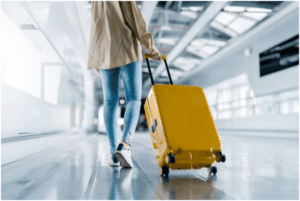 Walking in an airport with yellow luggage