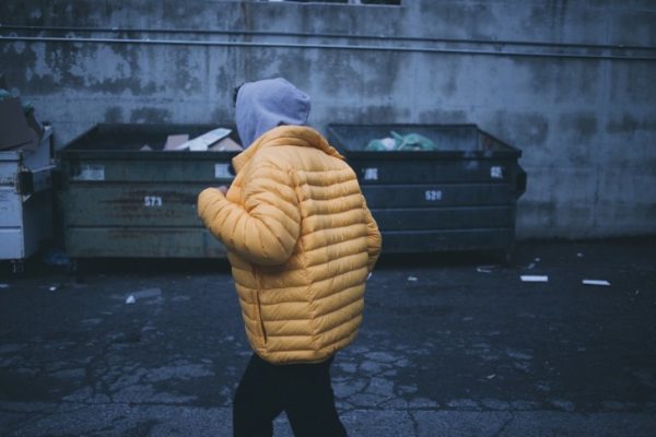 A man by the dumpsters