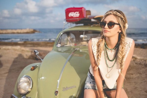 A girl sitting on a car