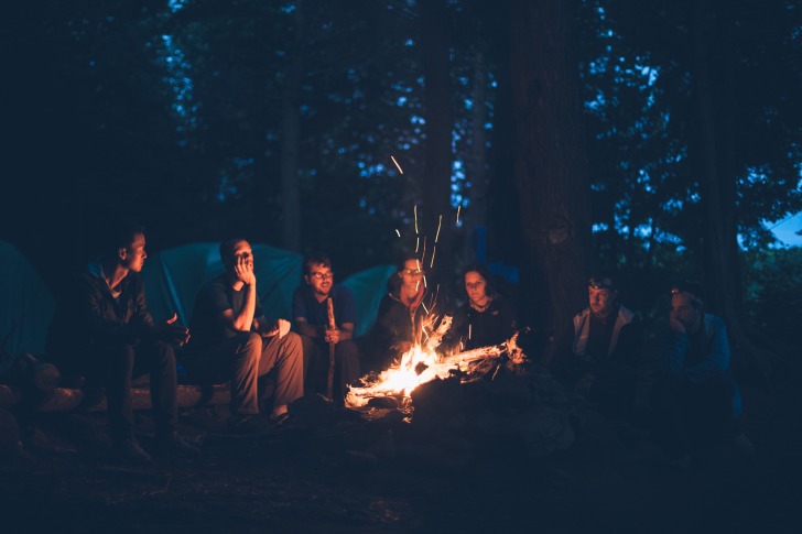 Group sitting at bonfire