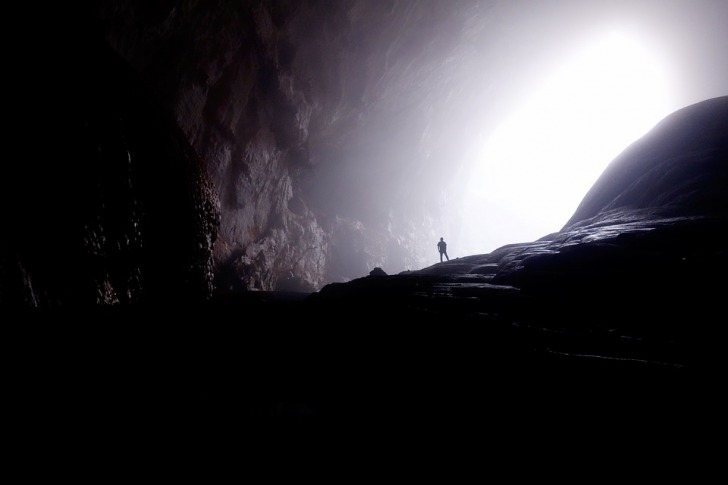 Man watching light in the end of the cave