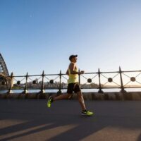 Man running in a yellow tank top