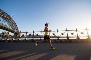 Man running in a yellow tank top