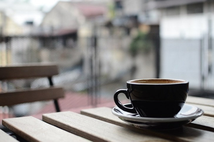 A cup of coffee at the wooden table