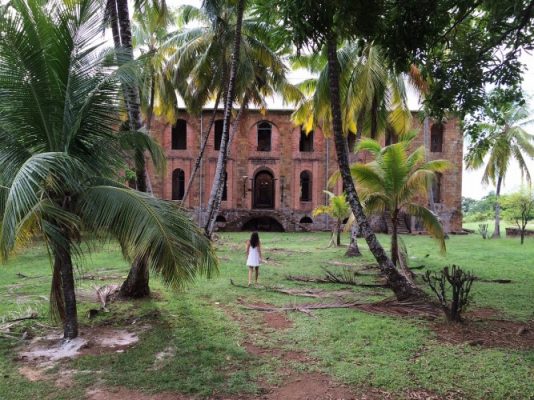 A girl in front of a deserted house