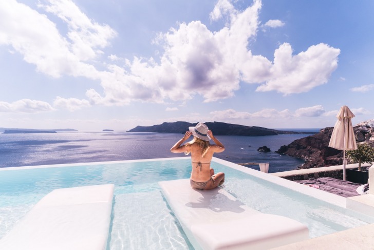 female by the pool and the sea on vacation