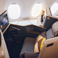 The interior of an Etihad Airways business class cabin, specifically featuring their new Business Class Suites on the Airbus A350-1000 aircraft.