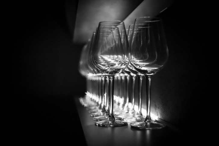 Row of glasses in darkness