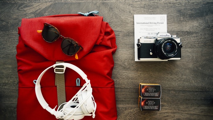 A backpack, headphones and a camera