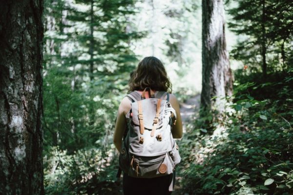 A girl with a backpack hiking 