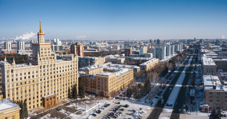 Aerial; drone panoramic view of Chelyabinsk winter cityscape; academic campus of Ural State University; education system of technical professions, industrial workplaces; single industry city problems