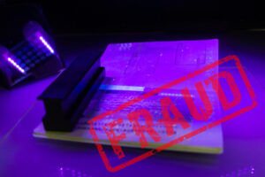 Process of the passport visa checking, close-up. The study of protective elements of the document in ultraviolet light. High security printing for for visa stickers. Passport protection against fraud