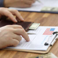 Male hands in suit lie on application for usa visa