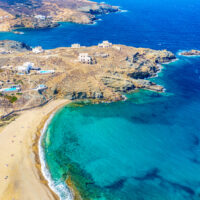 Aerial drone view of Fokos beach on Mykonos island, Greece.