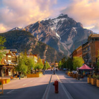 Sunrise Clouds Over A Mountain Road Through The Town Of Banff