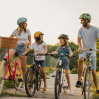 Happy family cycling together in the countryside