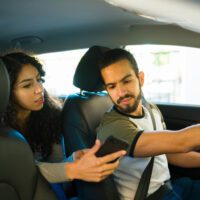 Woman passenger giving directions to the driver