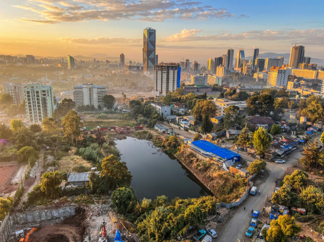 Aerial overview of Addis Abeba city, the capital of Ethiopia, showing brand new buildings and construction in the foreground, city centre and suburbs, Ethiopia