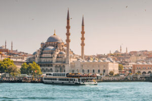 A Turkish ferryboat filled with tourists enjoying a scenic cruise across the sea, exploring the beauty of the city