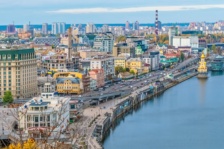 Aerial view of the bustling cityscape of Kyiv, Ukraine, featuring diverse architecture along the Dnipro River