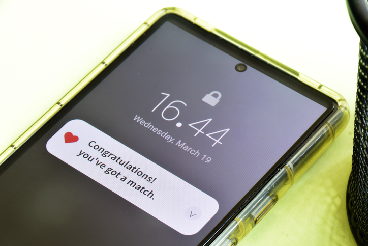 Close-up of Mobile congratulatory notification about a profile match in a dating app.