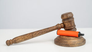 Judge's gavel hits disposable vape. Smoking ban.