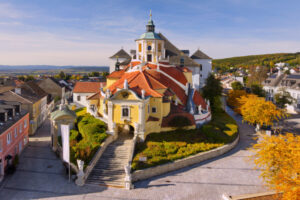 Aerial view of the beautiful Bergkirche (or Haydnkirche) in the capital of Burgenland (Austria) - Eisenstadt on an autumn morning