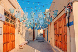 Muharraq Bahrain, Manama: blue fishing baskets hanging over an alleyway, showcasing traditional architecture and cultural heritage