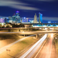 A long exposure of an elevated view of Kansas City, Missouri skyline at night.