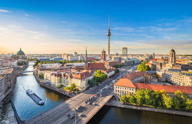 Berlin skyline with famous TV tower and Spree river in beautiful evening light at sunset, Germany