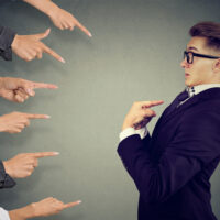 Blaming you. Anxious man judged by different people pointing fingers at him. Negative human emotions feeling