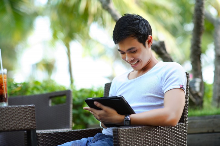 Young men smiling at smartphone