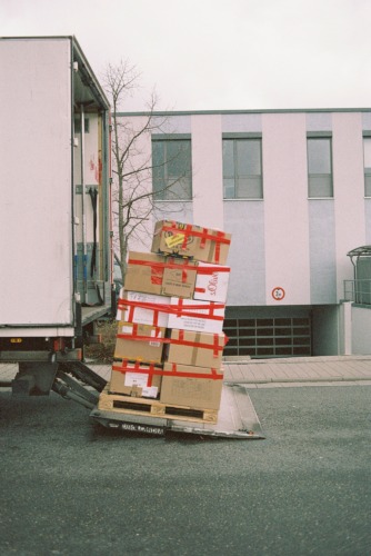 stacked pallet of items being unloaded from a truck using a lift gate