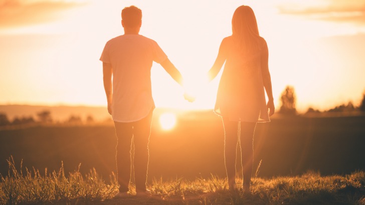 Couple holding hands in the sunset
