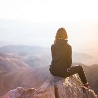 A girl sitting on the cliff