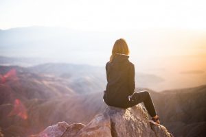 A girl sitting on the cliff