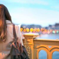 a person looking out over a city in the evening