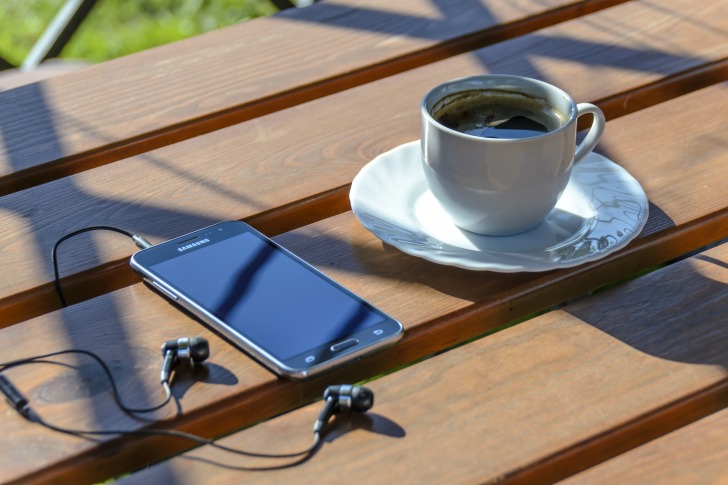 Smartphones, earphones and coffee
