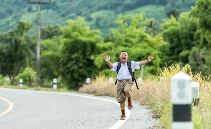 Happy schoolboy running