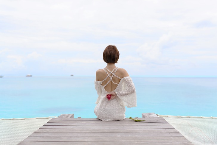 Woman in white at the pier