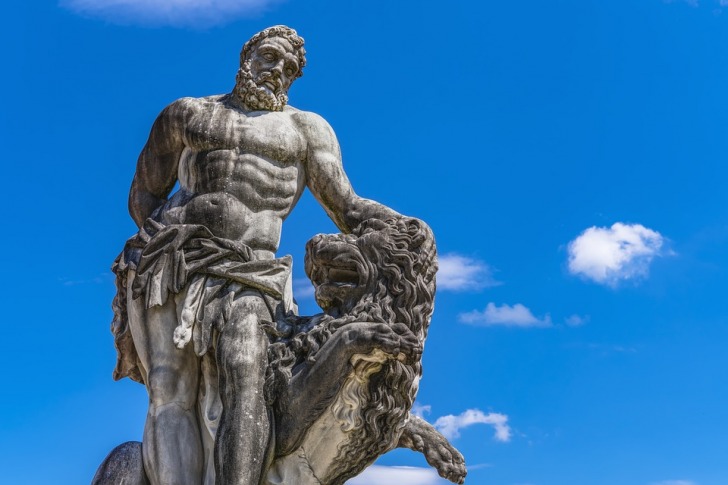 A statue of Hercules stroking a growling lion
