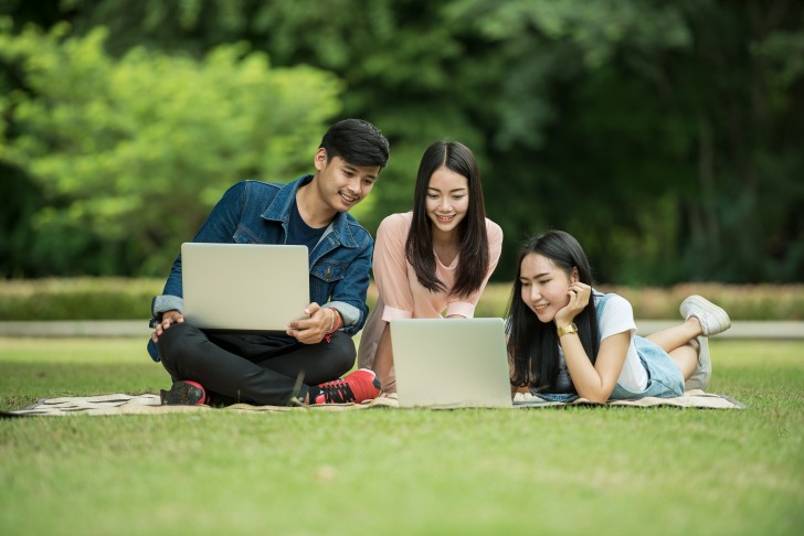 Boy and two girls with laptops