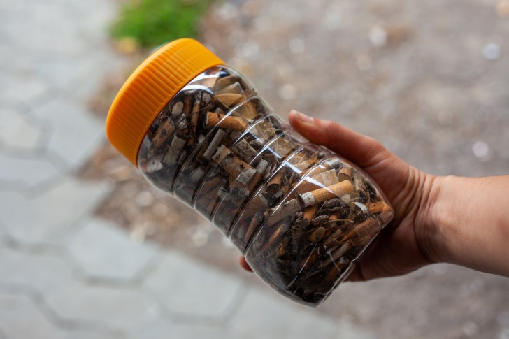 Cigarette butts in a jar