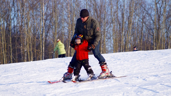 Man skiing with a kid