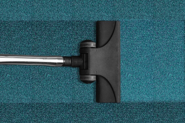 Vacuum cleaning the blue carpet